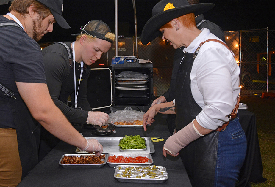 Se7enBites owner Trina Gregory and her staff prep a dish at Cows 'n Cabs..